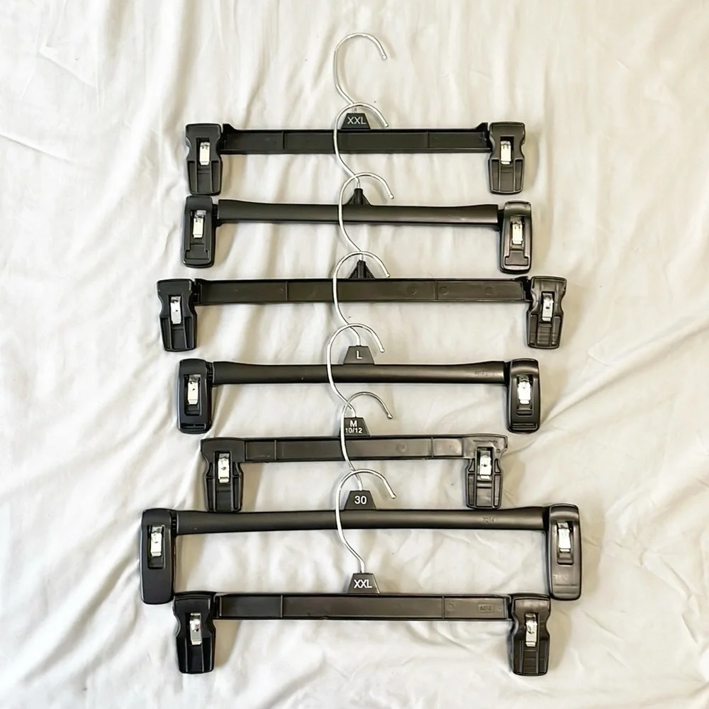 Set of 7 black plastic bottom hangers for clothes